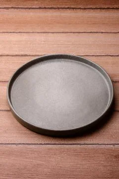 An empty ceramic round plate, kitchen utensils for a dinner table. An empty.. Stock Photos