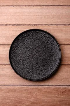 An empty ceramic round plate, kitchen utensils for a dinner table. An empty.. Stock Photos