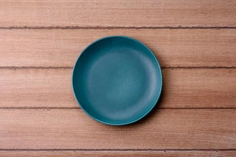 An empty ceramic round plate, kitchen utensils for a dinner table. An empty.. Stock Photos