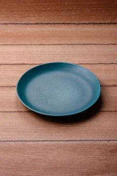 An empty ceramic round plate, kitchen utensils for a dinner table. An empty.. Stock Photos