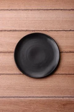 An empty ceramic round plate, kitchen utensils for a dinner table. An empty.. Stock Photos