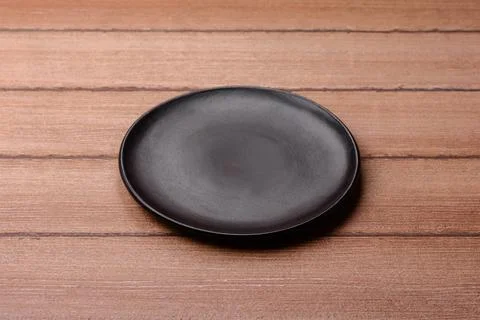 An empty ceramic round plate, kitchen utensils for a dinner table. An empty.. Stock Photos