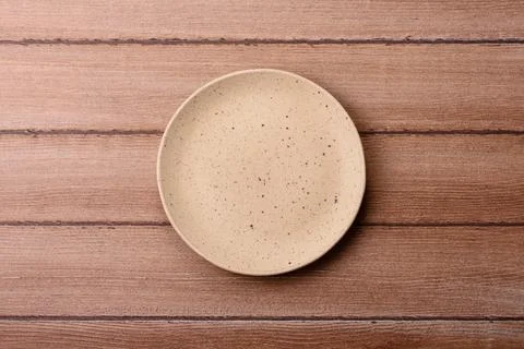 An empty ceramic round plate, kitchen utensils for a dinner table. An empty.. Stock Photos