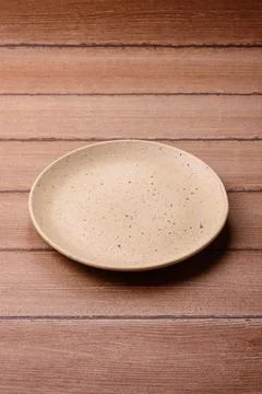 An empty ceramic round plate, kitchen utensils for a dinner table. An empty.. Stock Photos