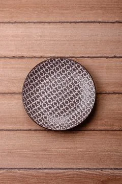 An empty ceramic round plate, kitchen utensils for a dinner table. An empty.. Stock Photos