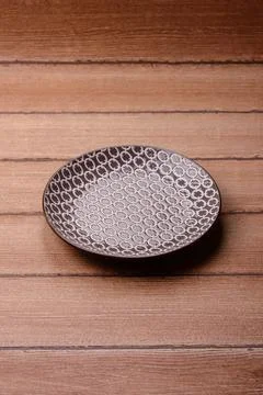 An empty ceramic round plate, kitchen utensils for a dinner table. An empty.. Stock Photos