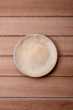 An empty ceramic round plate, kitchen utensils for a dinner table. An empty.. Stock Photos