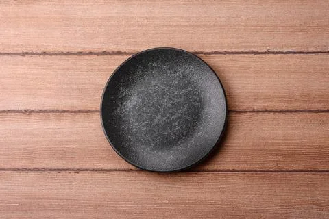 An empty ceramic round plate, kitchen utensils for a dinner table. An empty.. Stock Photos