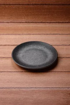 An empty ceramic round plate, kitchen utensils for a dinner table. An empty.. Stock Photos