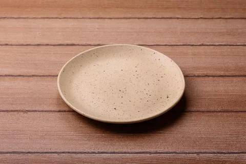 An empty ceramic round plate, kitchen utensils for a dinner table. An empty.. Stock Photos