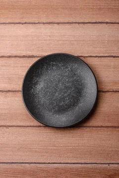 An empty ceramic round plate, kitchen utensils for a dinner table. An empty.. Stock Photos