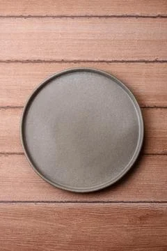 An empty ceramic round plate, kitchen utensils for a dinner table. An empty.. Stock Photos