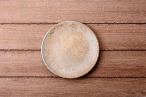 An empty ceramic round plate, kitchen utensils for a dinner table. An empty.. Stock Photos