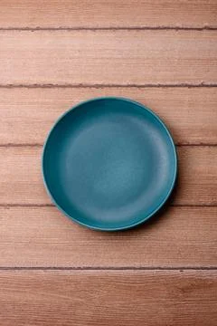 An empty ceramic round plate, kitchen utensils for a dinner table. An empty.. Stock Photos