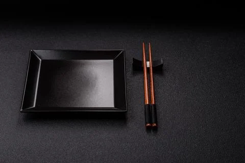 An empty ceramic square black plate with chopsticks for Asian food. An empt.. Stock Photos