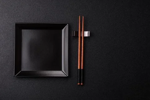 An empty ceramic square black plate with chopsticks for Asian food. An empt.. Stock Photos