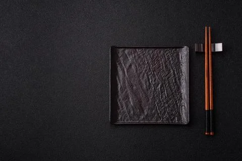 An empty ceramic square black plate with chopsticks for Asian food. An empt.. Stock Photos