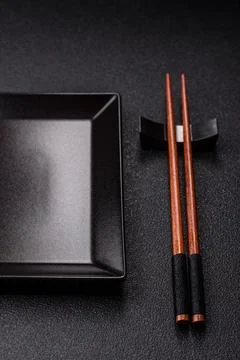 An empty ceramic square black plate with chopsticks for Asian food. An empt.. Stock Photos