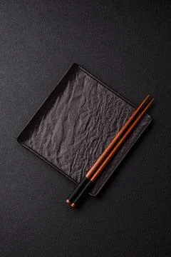 An empty ceramic square black plate with chopsticks for Asian food. An empt.. Stock Photos