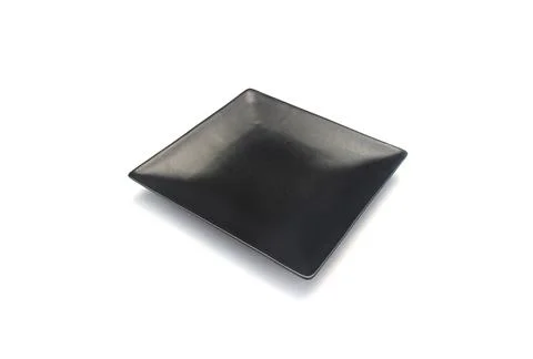 Empty ceramics black plate isolated on white background with clipping path Stock Photos