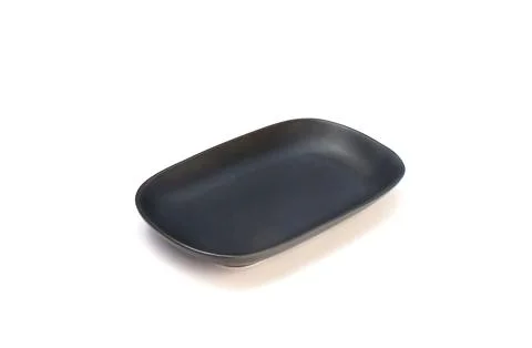 Empty ceramics black plate isolated on white background with clipping path Stock Photos