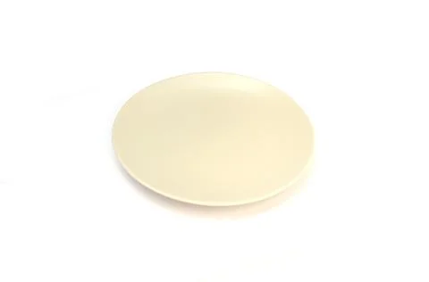 Empty ceramics white plate isolated on white background with clipping path Stock Photos