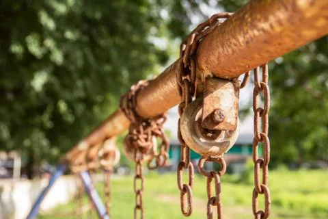 Empty chain swing in playground. Image of children swing set in park. Stock Photos
