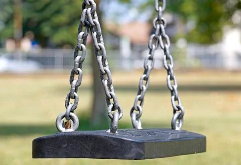 Empty chain swing in playground at park Stock Photos