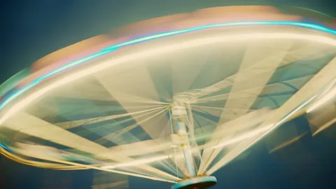 Empty chain swing ride lit with bright LED lights during evening twilight. .. Video stock 347268754