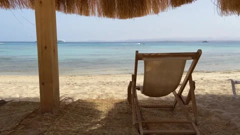 Empty chair beach and sun umbrella on sea background in sunny day, calm and.. Stock Footage 314395319