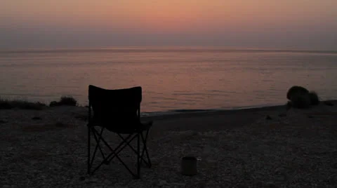 Empty chair on the beach at dusk Stock Footage 24737416