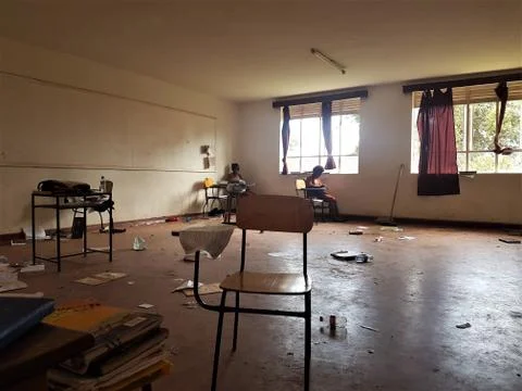 The empty chair in a classroom with a background of few girl students Stock-Fotos