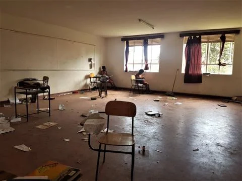 The empty chair in a classroom with a background of few girl students 写真素材
