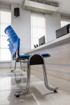 The empty chair before a desk with a computer in the office. Stock Photos