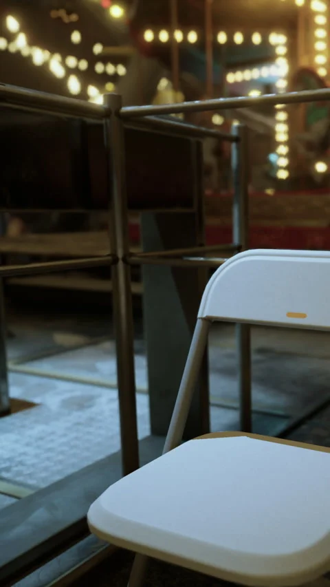 Empty chair in a venue with lights and stage in background during evening Stock Footage 339045122