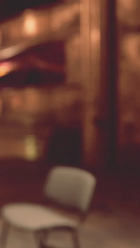 Empty chair in a warm setting with soft lighting and blurred background Stock Footage 339508044