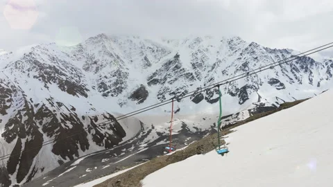 Empty chairlift moving on the ski resort with no people Stock Footage 156123717