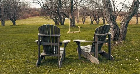 Empty chairs and swing set in spring Stock Photos