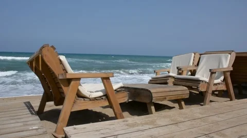 Empty chairs and table in a cafe on the beach by the sea in early morning Stock-Footage 242242728