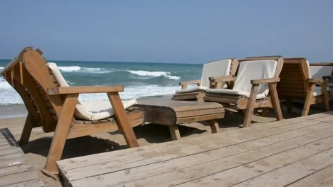 Empty chairs and table in a cafe on the beach by the sea in early morning Stock-Footage 242242731