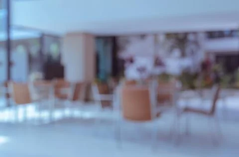 Empty chairs and table in coffee shop, blur background image Stock Photos
