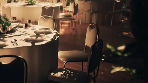 Empty chairs and table in a hall set for a gathering in the evening Stock Footage 343930204