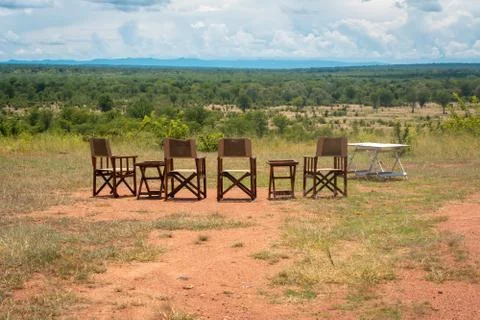 Empty chairs and table with view on the landscape of an African national park Stock Photos