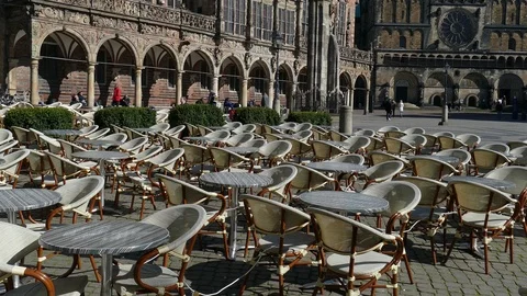 Empty chairs and tables of a cafe on Bremen's market square Stock Footage 127082840