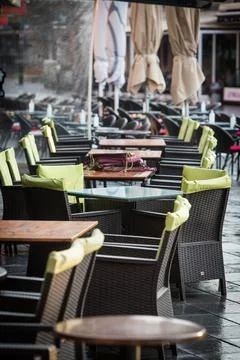 Empty chairs and tables at an open air terrace Stock Photos