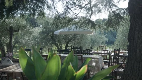 Empty Chairs And Tables With Parasol In An Outdoor Cafe In Italy. wide Stock Footage 224339725