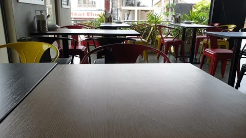 Empty chairs and tables in pizza restaurant in day time. Video stock 129480919