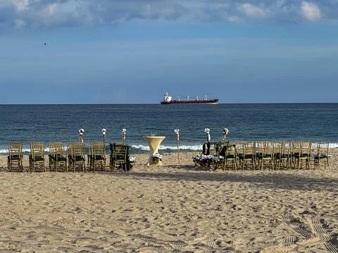 Empty chairs are set up for Florida beach wedding Stock Photos