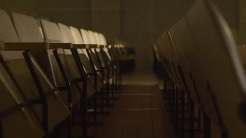 Empty chairs in auditorium colored by spotlight Stock Footage 208669353