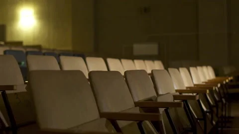 Empty chairs in auditorium colored by spotlight Video stock 208673059